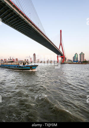 Domestic waste container transport sanitation ship travels on the surface of the Huangpu River, a landmark landscape in Shanghai. Stock Photo