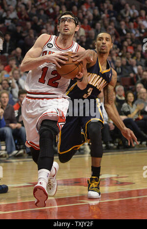 Chicago Bulls guard Kirk Hinrich (L) drives to the basket as Indiana Pacers guard George Hill defends during the fourth quarter at the United Center in Chicago on March 24, 2014. The Bulls defeated the Pacers 89-77.      UPI/Brian Kersey Stock Photo