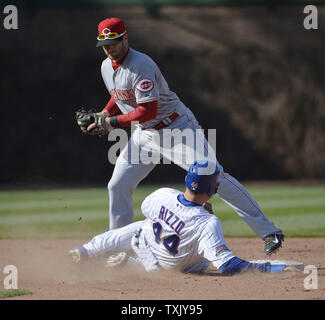 Cincinnati Reds shortstop Zack Cozart (L) forces out Chicago Cubs' Anthony Rizzo at second base on a ground ball hit by Nate Schierholtz during the eighth inning at Wrigley Field on April 18, 2014 in Chicago. The Reds defeated the Cubs 4-1.      UPI Photo/Brian Kersey Stock Photo