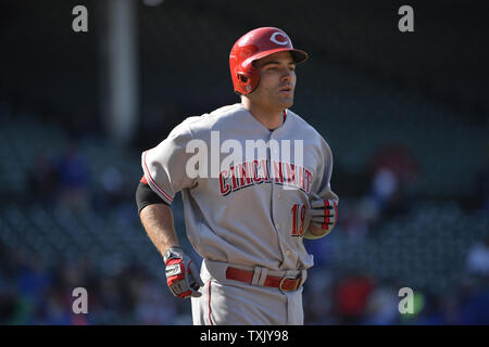 Cincinnati Reds' Joey Votto walks onto the field with his gear prior to a spring  training baseball game against the Chicago Cubs Saturday, March 27, 2021,  in Goodyear, Ariz. (AP Photo/Ross D.