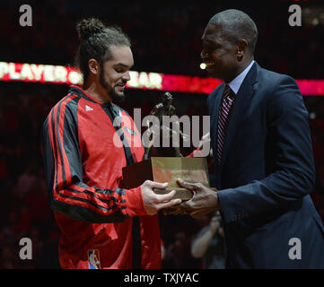 Chicago Bulls center Joakim Noah accepts the 2013-2014 Defensive Player of the Year award from former NBA player and four-time recipient of the award Dikembe Mutombo before Game 2 of the NBA Eastern Conference quarterfinals against the Washington Wizards at the United Center on April 22, 2014 in Chicago.     UPI/Brian Kersey Stock Photo