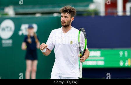 Eastbourne, UK. 25th June, 2019. Juan Ignacio Lóndero of Argentina in action against Jay Clarke of Great Britain during their match at the Nature Valley International tennis tournament held at Devonshire Park in Eastbourne . Credit: Simon Dack/Alamy Live News Stock Photo