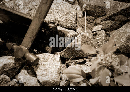 Smartphone broken glass with hammer on gravel stones. Selective focus. Stock Photo
