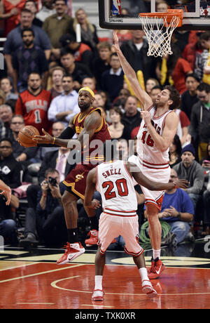 Cleveland Cavaliers forward LeBron James (L) throws up a no-look shot for a score as Chicago Bulls forward Pau Gasol defends during overtime at the United Center in Chicago on October 31, 2014. The Cavaliers defeated the Bulls 114-108 in overtime.     UPI/Brian Kersey Stock Photo