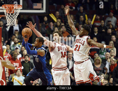 Dallas Mavericks guard Monta Ellis (L-R) drives to the basket as Chicago Bulls forward Pau Gasol and guard Jimmy Butler defend during the second overtime at the United Center on December 2, 2014 in Chicago. The Mavericks defeated the Bulls 132-129 in double overtime.     UPI/Brian Kersey Stock Photo