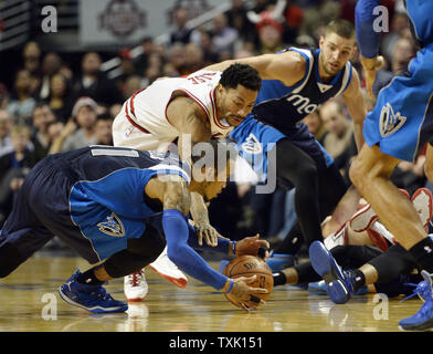 Chicago Bulls guard Derrick Rose (C) and Dallas Mavericks guard Monta Ellis go for the ball during the fourth quarter at the United Center on December 2, 2014 in Chicago. The Mavericks defeated the Bulls 132-129 in double overtime.     UPI/Brian Kersey Stock Photo