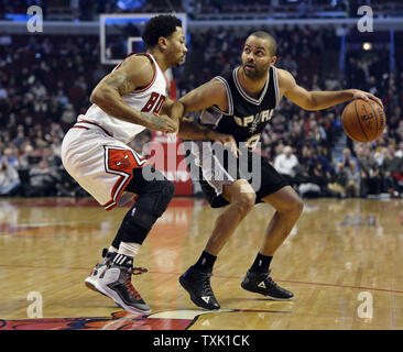 San Antonio Spurs guard Tony Parker (R) drives on Chicago Bulls guard Derrick Rose during the first quarter at the United Center in Chicago on January 22, 2015.     UPI/Brian Kersey Stock Photo