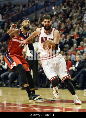 Chicago Bulls forward Nikola Mirotic (R) drives by Washington Wizards forward Drew Gooden during the fourth quarter at the United Center in Chicago on March 3, 2015. The Bulls defeated the Wizards 97-92.     Photo by Brian Kersey/UPI Stock Photo