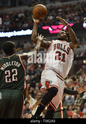 Chicago Bulls guard Jimmy Butler (R) shoots as Milwaukee Bucks guard Khris Middleton defends during the second quarter of game 2 the first round of the NBA Playoffs at the United Center on April 20, 2015 in Chicago. The Bulls defeated the Bucks 91-82 and lead the best of seven series 2-0.     Photo by Brian Kersey/UPI Stock Photo