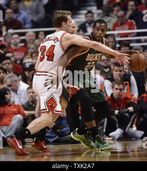 Chicago Bulls forward Mike Dunleavy (L) fouls Milwaukee Bucks guard Khris Middleton during the first quarter of game 5 the first round of the NBA Playoffs at the United Center on April 27, 2015 in Chicago.     Photo by Brian Kersey/UPI Stock Photo