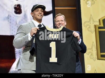 Stanford's Andrus Peat (L) stands with NFL Commissioner Roger Goodell after he was selected 13th overall by the New Orleans Saints during the first round of the NFL Draft on April 30, 2015 in Chicago.     Photo by Brian Kersey/UPI Stock Photo