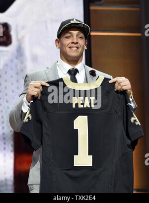Stanford's Andrus Peat holds his jersey after he was selected 13th overall by the New Orleans Saints during the first round of the NFL Draft on April 30, 2015 in Chicago.     Photo by Brian Kersey/UPI Stock Photo