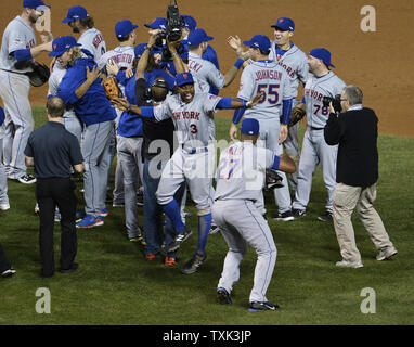 New York Mets Curtis Granderson (3) and Jeurys Familia (27) celebrate their 8-3 victory over the Chicago Cubs after game 4 of the National League Championship Series at Wrigley Field in Chicago on October 20, 2015.   Photo by Jim Prisching/UPI Stock Photo