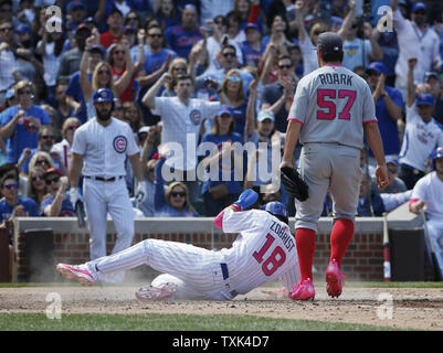 Chicago Cubs second baseman Ben Zobrist (18) scores on a wild pitch by Washington Nationals starting pitcher Tanner Roark (57) during the fourth inning at Wrigley Field in Chicago on May, 8, 2016. Photo by Kamil Krzaczynski/UPI Stock Photo
