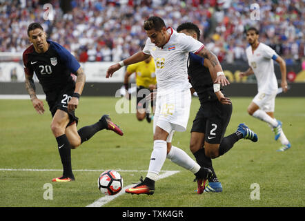 Costa Rica defender Ronald Matarrita (C) mover the ball as United States defender Geoff Cameron (L) and defender DeAndre Yedlin (2) try to steal during the first half of a 2016 Copa America Centenario Group A match at Soldier Field in Chicago on June 7, 2016. The United States defeated Costa Rica 4-0.     Photo by Brian Kersey/UPI Stock Photo