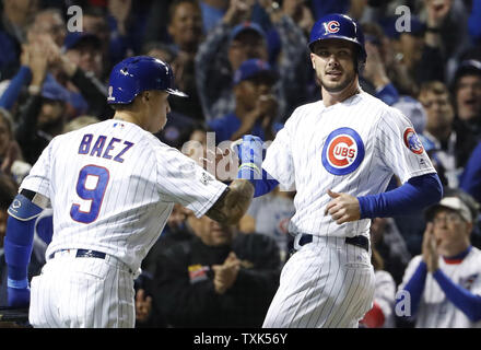 Milwaukee, WI, USA. 6th Apr, 2018. Chicago Cubs second baseman Javier Baez  #9 is congratulated after scoring on a triple and a throwing error in the  5th inning of the Major League