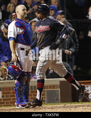 Cleveland Indians Francisco Lindor (L) and Rajai Davis leap to