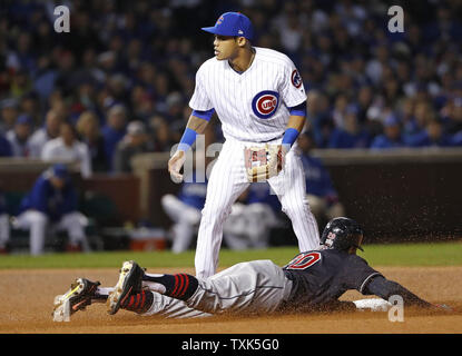 Cleveland Indians Francisco Lindor (L) and Rajai Davis leap to