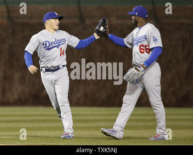 Los Angeles Dodgers' Kike Hernandez, left, slips by Colorado