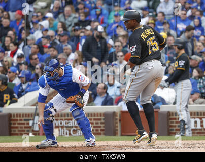 Pittsburgh Pirates Francisco Cervelli (29) and home plate umpire DJ  Reyburn, left, react after both being hit by a pitch as Toronto Blue Jays  catcher Dioner Navarro, centre, looks to help during