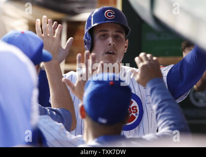 Chicago Cubs' Anthony Rizzo (L) celebrates with Kris Bryant (17) and Javier  Baez (9) celebrates with Addison Russell (R) after defeating the Los  Angeles Dodgers 5-0 in game 6 to win the