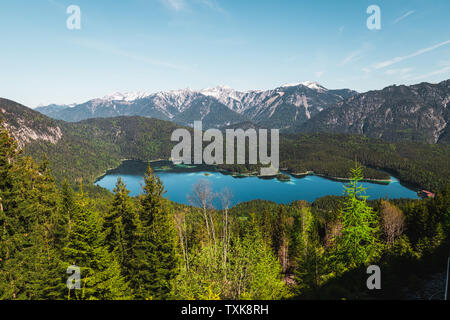 View onto crystal clear blue Eibsee as seen from track of Bavarian Zugspitz Railway on its ascent to Zugspitze during clear summer day (Germany) Stock Photo
