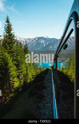 View onto crystal clear Eibsee as seen from inside Zugspitzbahn / Bavarian Zugspitz  Railway during the ascent to Germanys highest mountain (Germany) Stock Photo