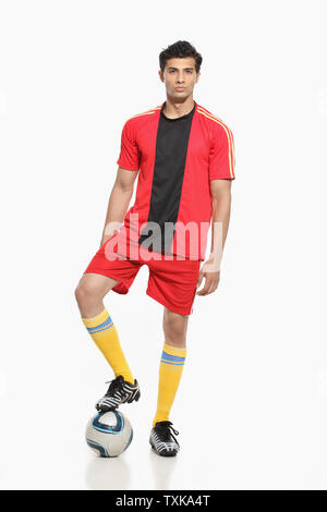 Portrait of a man standing with soccer ball Stock Photo