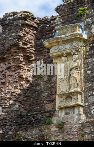 The remains of an ornate fire place in the Long Galley at Raglan Castle, Wales Stock Photo