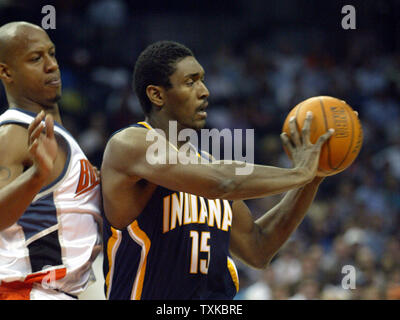Indiana Pacers forward Ron Artest, right, passes as Charlotte Bobcats guard Keith Bogan plays defense at the Charlotte Bobcats Arena in Charlotte, N.C. on November 16, 2005. (UPI Photo/Nell Redmond) Stock Photo