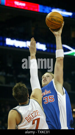 Los Angeles Clippers center Chris Kaman, right, shoots over Charlotte Bobcats center Primoz Brezec at the Charlotte Bobcats Arena in Charlotte, N.C. on December 23, 2005. (UPI Photo/Nell Redmond) Stock Photo