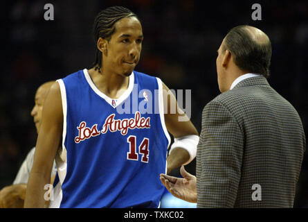 Los Angeles Clippers guard Shaun Livingston, left, listens to head coach Mike Dunleavy as the Clippers play the Charlotte Bobcats at the Charlotte Bobcats Arena in Charlotte, N.C. on December 23, 2005. (UPI Photo/Nell Redmond) Stock Photo