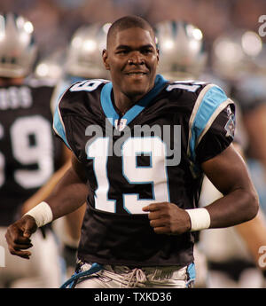 Carolina Panthers wide receiver Keyshawn Johnson (19) knocks the helmet off  of St. Louis Rams cornerback Tye Hill (26) during his 36-yard pass  reception in the fourth quarter of the Panthers 15-0