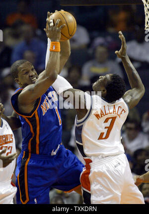 Charlotte Bobcats guard Gerald Wallace (R) and New York Knicks guard Steve Francis battle for a rebound in the first half at the Charlotte Bobcats Arena in Charlotte, North Carolina on April 18, 2007. (UPI Photo/Nell Redmond) Stock Photo
