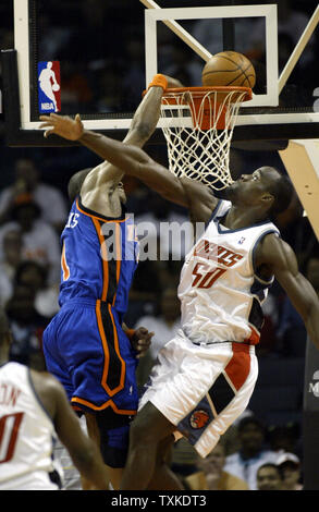 New York Knicks guard Steve Francis (L) misses a dunk over Charlotte Bobcats center Emeka Okafor in the first half at the Charlotte Bobcats Arena in Charlotte, North Carolina on April 18, 2007. (UPI Photo/Nell Redmond) Stock Photo