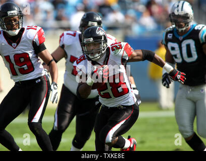 Running back Warrick Dunn of the Atlanta Falcons holds the ball