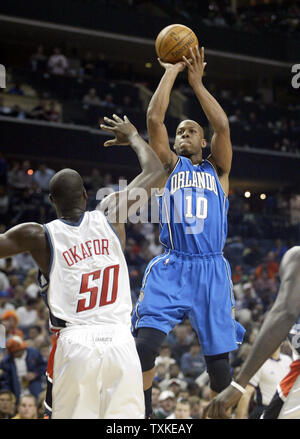 Orlando Magic guard Keith Bogans, center, is helped off of the court by ...