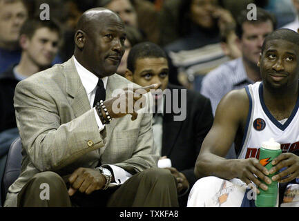 Charlotte Bobcats part owner and managing member of basketball operations Michael Jordan, left, talks with guard Raymond Felton as the Bobcats defeat the Boston Celtics 114-106 in overtime in Charlotte, North Carolina on January 6, 2009. (UPI Photo/Nell Redmond) Stock Photo