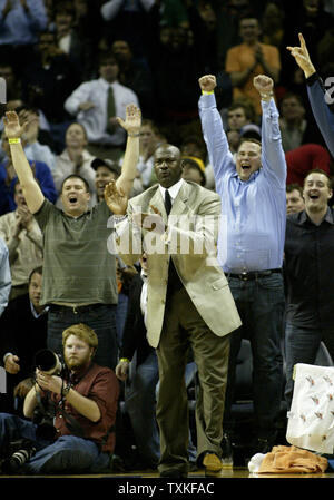 Charlotte Bobcats part owner and managing member of basketball operations Michael Jordan, center, applauds the effort of his Charlotte Bobcats as they defeat the Boston Celtics 114-106 in overtime in Charlotte, North Carolina on January 6, 2009. (UPI Photo/Nell Redmond) Stock Photo