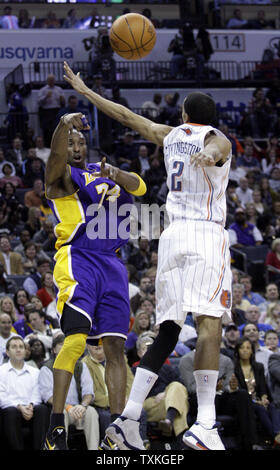 Los Angeles Lakers guard Kobe Bryant passes aroud Charlotte Bobcats guard Shaun Livingston in the first half of in an NBA basketball game in Charlotte, North Carolina on February 14, 2011.    UPI/Nell Redmond Stock Photo