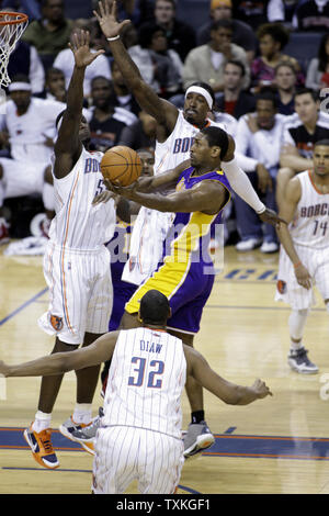 Los Angeles Lakers forward Ron Artest drives to the basket against Charlotte Bobcats Kwame Brown, left, and Gerald Wallace in the second half of in an NBA basketball game in Charlotte, North Carolina on February 14, 2011. Charlotte won 109-89.  UPI/Nell Redmond Stock Photo