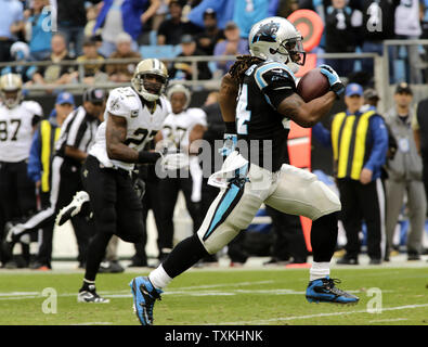 Carolina Panthers running back John Lovett (37) runs between Buffalo Bills  defensive tackle Prince Emili (94) and inebacker Andre Smith (9) during an  NFL preseason football game on Friday, Aug. 26, 2022