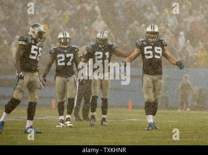 Carolina Panthers (L-R) Thomas Davis, Quentin Mikell, Mike Mitchell, and  Luke Kuechly stand on the field as the rain pours during the second half of  a game against the New Orleans Saints