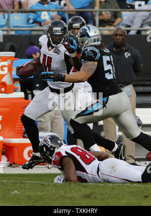 Atlanta Falcons wide receiver Julio Jones,  left, carries the ball as Carolina Panthers linebacker A.J. Klein closes to make the tackle  in the second half of an NFL football game at Bank of America Stadium in Charlotte, North Carolina on December 13, 2015. Carolina won 38-0.   UPI/Nell Redmond . Stock Photo