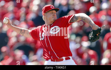 Cincinnati Reds pitcher Mat Latos shows his tattoos as he poses for a  picture during the team's photo day before spring training baseball  workouts Thursday, Feb. 20, 2014, in Goodyear, Ariz. (AP