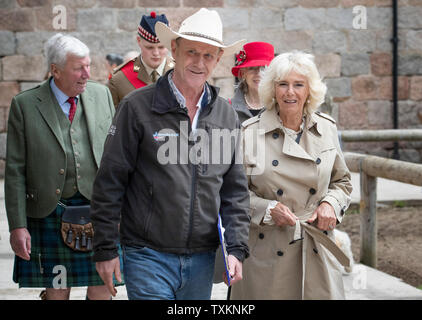The Duchess of Cornwall, who is known as the Duchess of Rothesay when in Scotland, with founder Jock Hutchison (centre) during a visit to HorseBack UK, in South Ferrar, Aboyne. The charity which supports veterans and children is celebrating its 10th birthday. Stock Photo