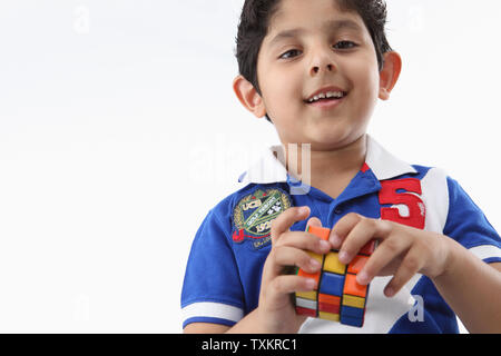 Boy playing with a puzzle cube Stock Photo
