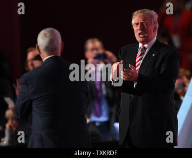 Republican presidential candidate Donald Trump applauds his running mate Indiana Governor Mike Pence on stage after Pence spoke on day three of the Republican National Convention at Quicken Loans Arena in Cleveland, Ohio on July 20,  2016.  Donald Trump will formally accept the Republican Party's nomination for President on Thursday night July 21.  Photo by Pat Benic/UPI Stock Photo