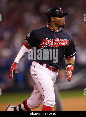 Cleveland Indians Francisco Lindor (L) and Rajai Davis leap to