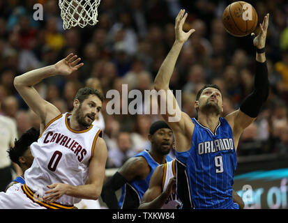 Orlando Magics' Nikola Vucevic grabs a rebound over Cleveland Cavaliers' Kevin Love during the first half at Quicken Loans Arena in Cleveland on April 4, 2017.   Photo by Aaron Josefczyk/UPI Stock Photo
